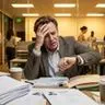 An empty office chair at a desk symbolizing the cost of an unfilled role versus a bad hire