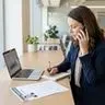 Hiring manager conducting a reference check over the phone with notes in front of them