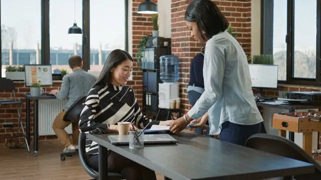 HR professional reviewing resume with job candidate