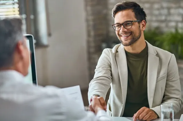 Manager shaking hands with new hire after successful interview