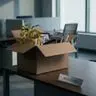 Empty office desk with packed personal items after a failed hire